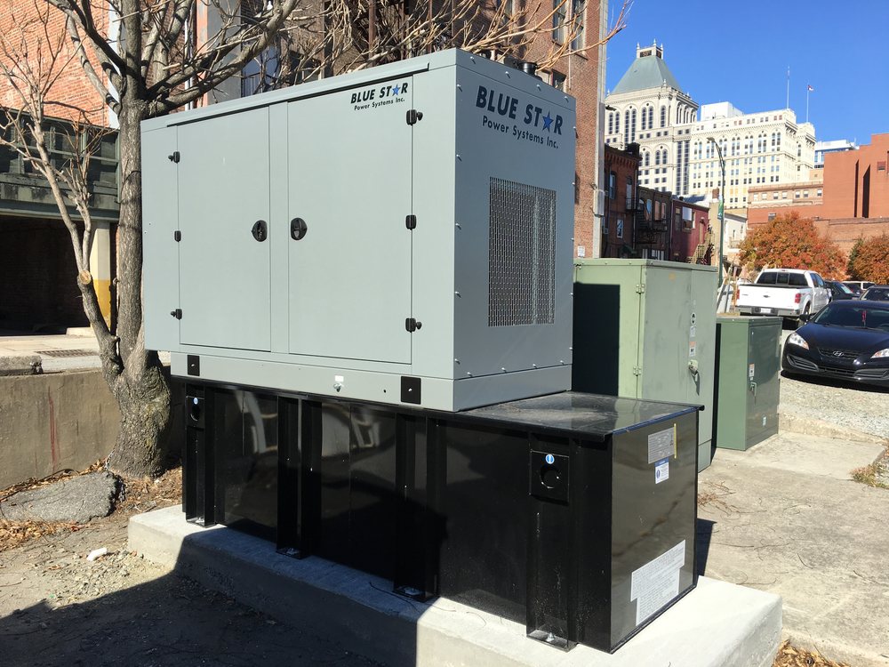 Carolina Digital Phone standby generator with over 600 gallons of diesel in downtown Greensboro, with the Greensboro skyline behind it
